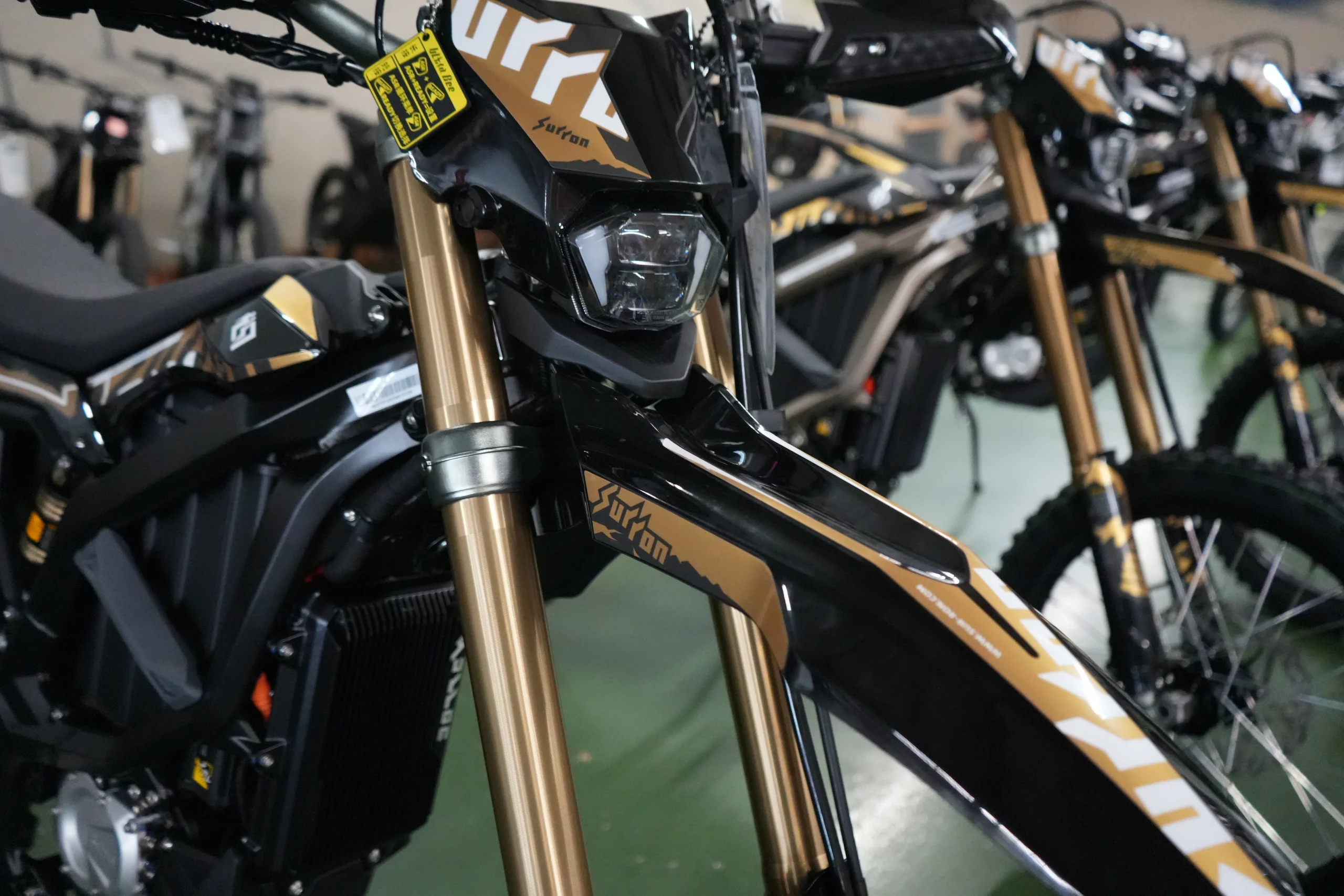 2026 Surron Ultra Bee in Desert Brown with gold-anodized forks